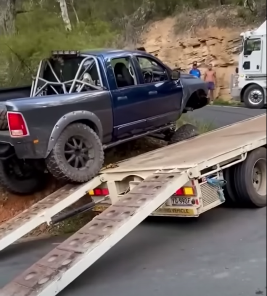 Ram truck crawling over a semi-truck