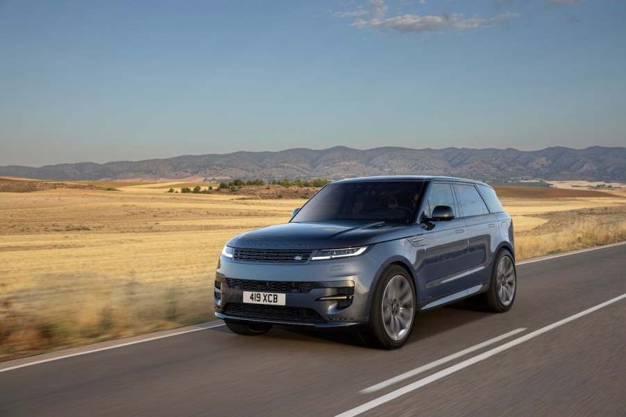 The 2024 Land Rover Range Rover Sport driving down a desert road in gray.