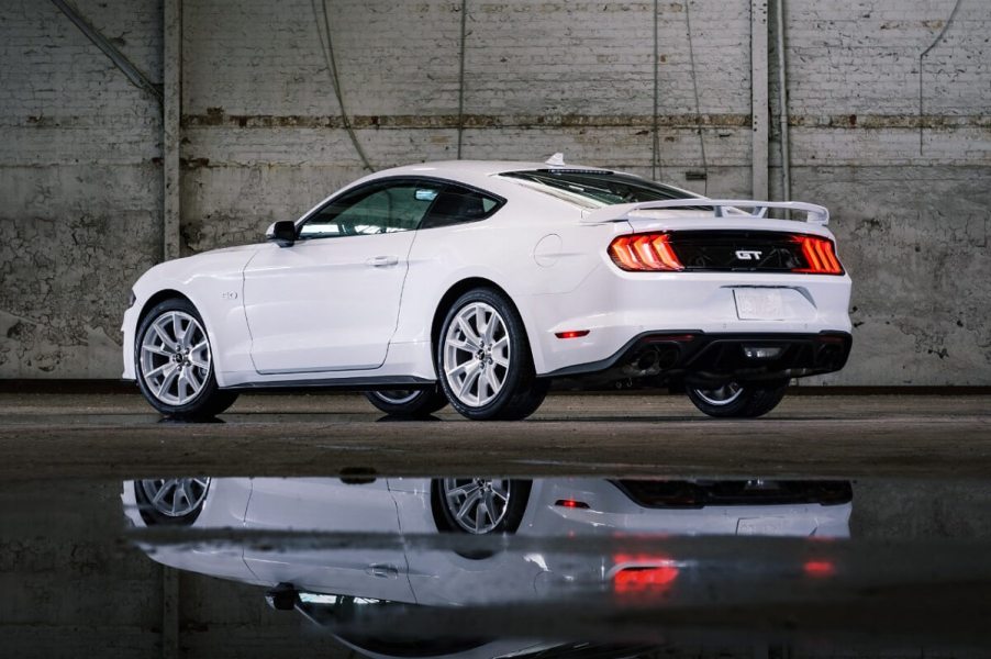 A white Ford Mustang GT Coupe sports car reflects.