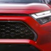 The front of a red 2023 Toyota RAV4 Prime small plug-in hybrid SUV.