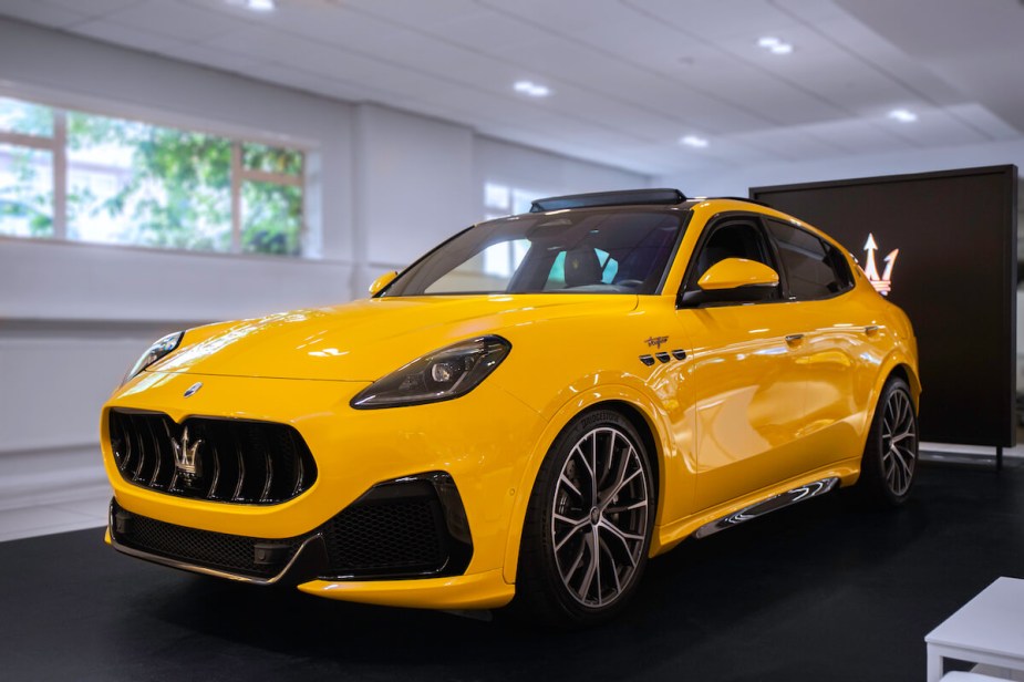 A Yellow Maserati SUV in a showroom - this SUV could have higher resale value due to its unique color.