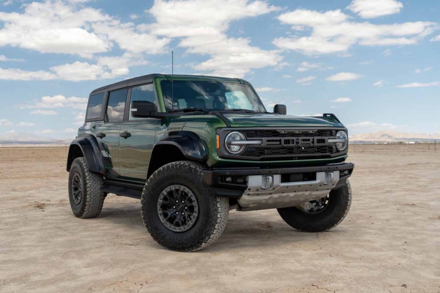 Green Ford Bronco Raptor sitting on a dry lake bed in Southerrn California