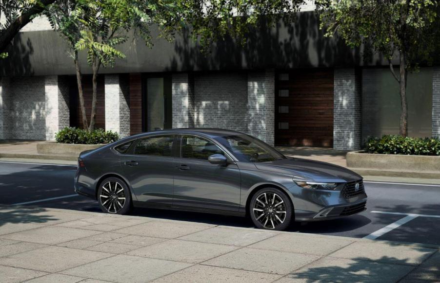 A 2023 Honda Accord Touring midsize sedan model parked on a street curb under tree shade