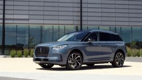 A 2023 Lincoln Corsair Grand Touring compact luxury SUV model parked on the plaza outside an office building