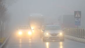 Fog reducing visibility on a road in Edirne, Turkey, as cars navigate with headlights and fog lights