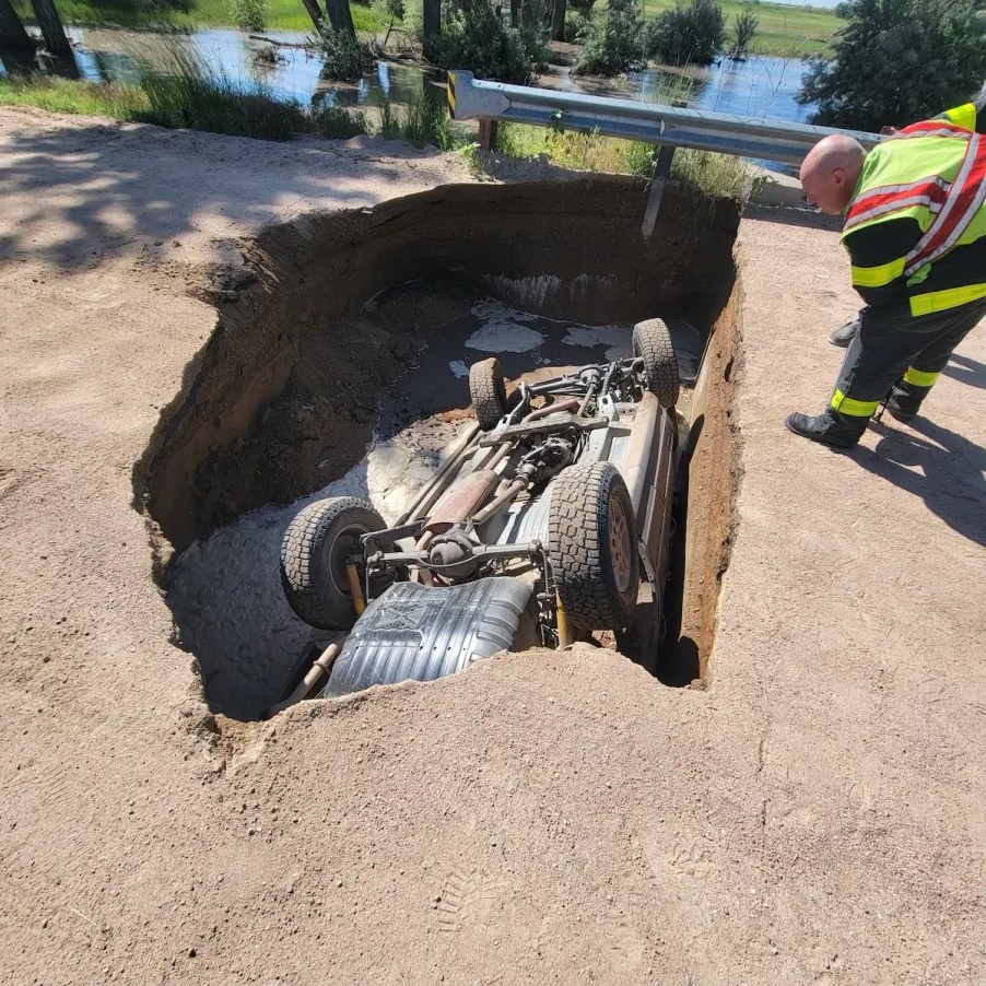 Jeep Grand Cherokee upside down inside of sinkhole | Colorado State Police