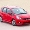 A 2013 Honda Fit Sport hatchback model in red