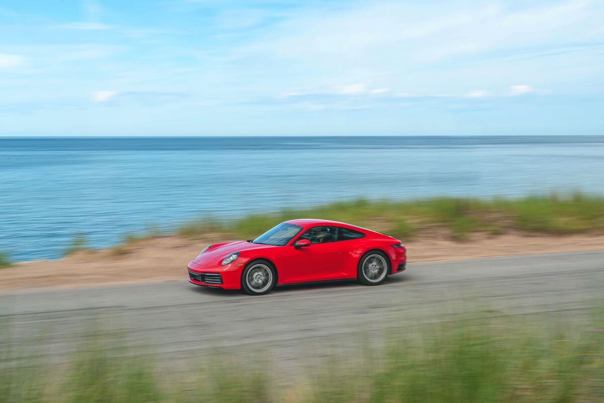 A red Porsche 911 sports car with all-wheel drive