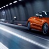 Toyota Daihatsu Copen GR Sport Convertible driving through a tunnel at night in bright orange sports car