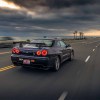 R34 Nissan Skyline GT-R V-Spec Midnight Purple II Driving Down Beach in Sunset