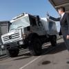 Daimler AG's Wolfgan Bernhard waving to a passing Mercedes-Benz Unimog model in Stuttgart, Germany