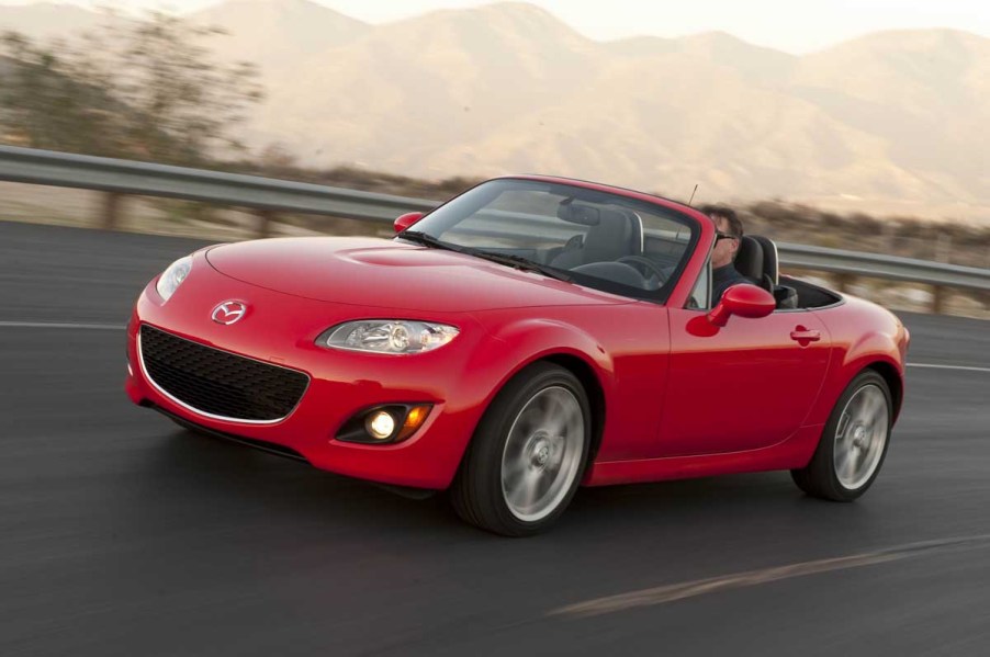 bright red NC Mazda Miata driving down the road