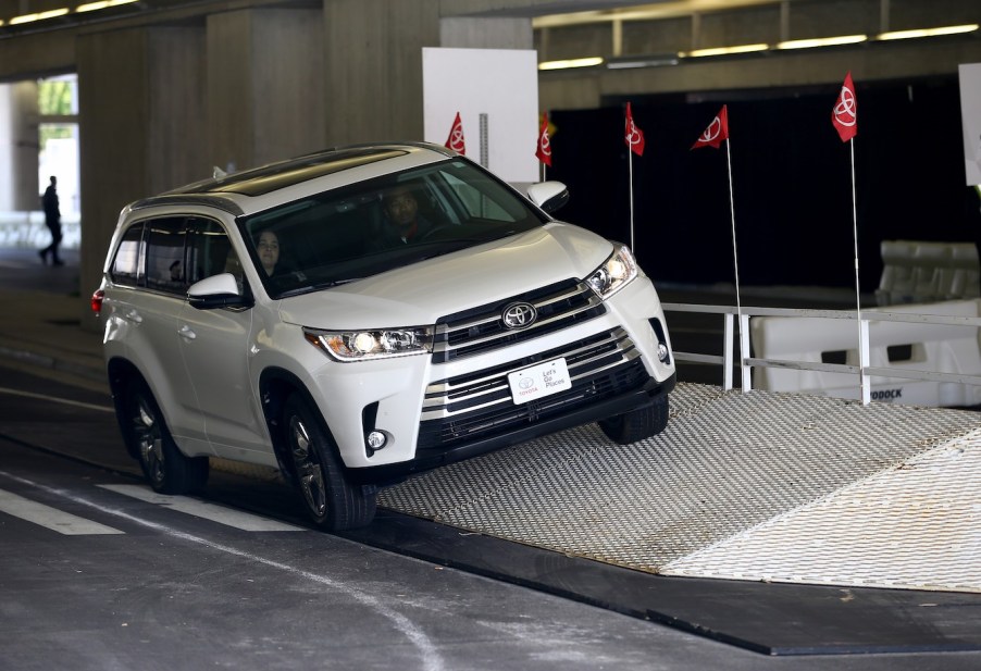 A white 2018 Toyota Highlander, one of the best used three-row SUV options.