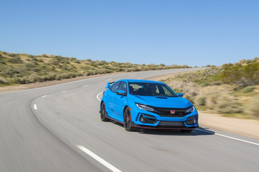 A Boost Blue Honda Civic Type R driving on a track