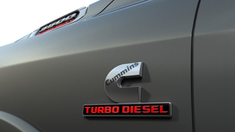 Closeup of the Cummins Turbo Diesel badge on the fender of a Ram 3500 heavy-duty pickup truck.