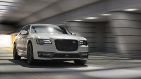 A white 2023 Chrysler 300C barrels through a tunnel.