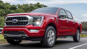 A bright red 2023 Ford F-150 on the road