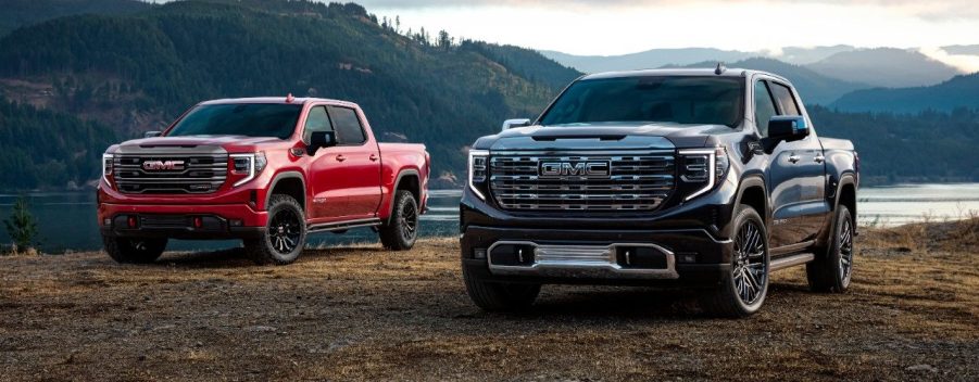 2 2023 GMC Sierra 1500 trucks parked next to each other.