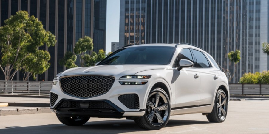 A white 2023 Genesis GV70 small luxury SUV is parked.