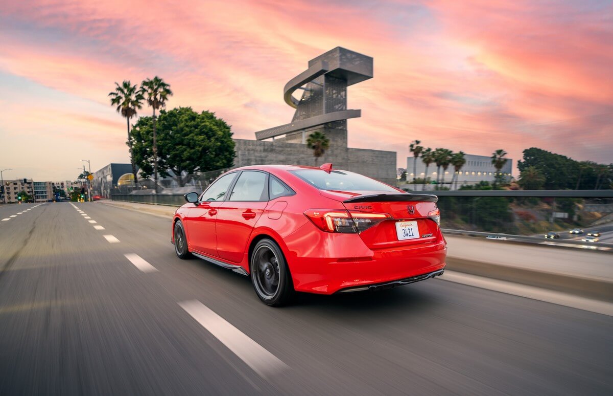 A rear view of the 2023 Honda Civic driving