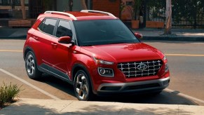 A red 2023 Hyundai Venue subcompact SUV is parked.