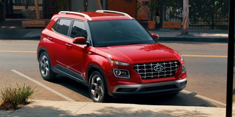 A red 2023 Hyundai Venue subcompact SUV is parked.