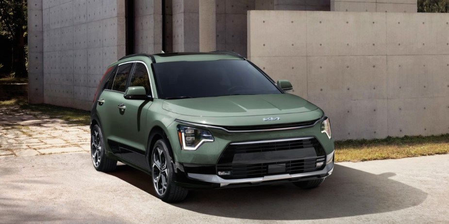 A green 2023 Kia Niro subcompact hybrid SUV is parked outside. 