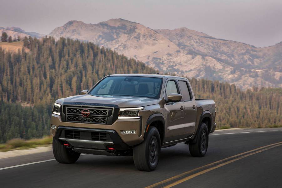 The 2023 Nissan Frontier on a scenic road in the mountains