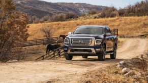 The 2023 Nissan Titan on a dirt road