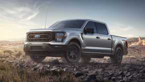 The 2023 Ford F-150 Rattler off-roading over rocks