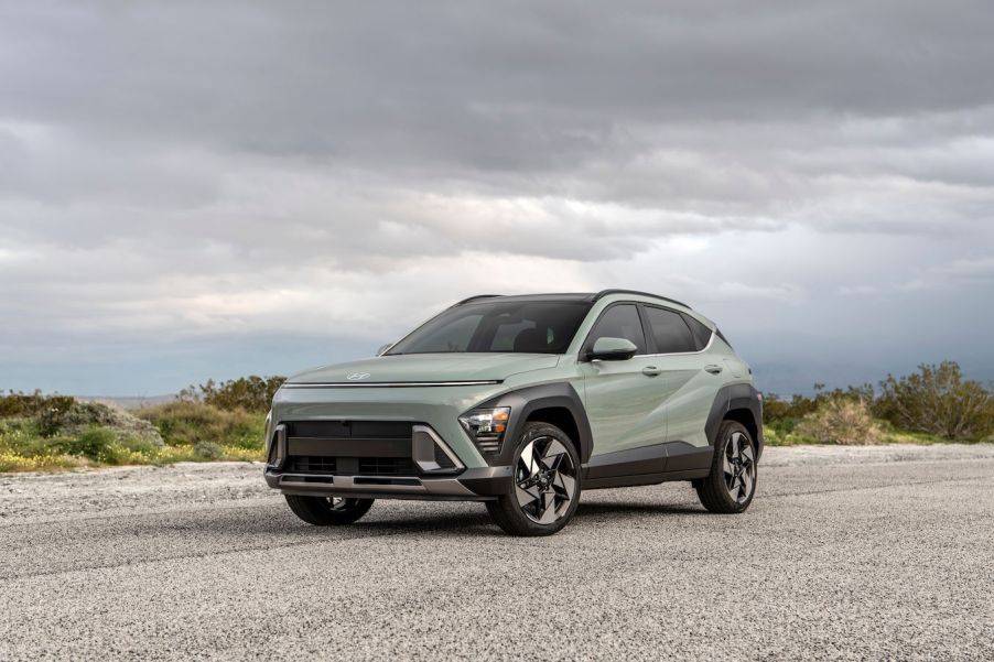 A green 2024 Hyundai Kona parked on a cloudy day. The Hyundai Kona sales beat out the Kia Seltos so far this year