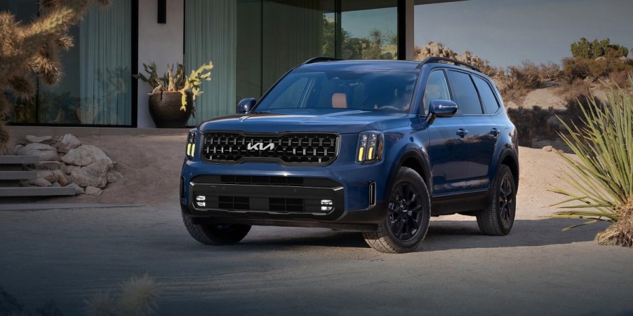 A blue 2024 Kia Telluride is parked outdoors.