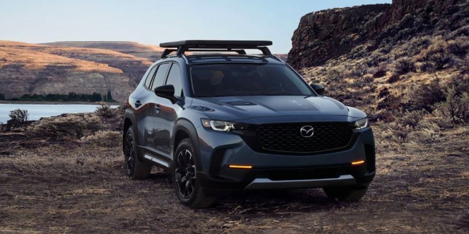 A blue 2024 Mazda CX-50 small SUV is parked outdoors. 