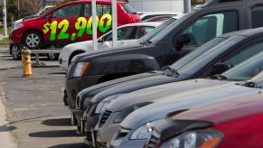 A line of cars on a dealership lot