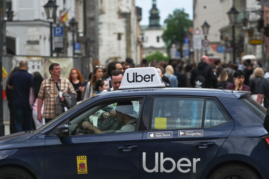 Uber taxi services car with Uber signage