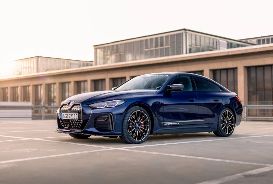 The BMW i4 M50 all-electric compact sedan model in Tanzanit Blue in a parking lot