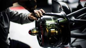 The McLaren Formula One racing team working on the left brake of a MP4-29 car for the 2014 Canadian Grand Prix