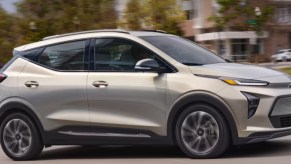 A gray 2023 Chevrolet Bolt EUV subcompact electric SUV is driving.