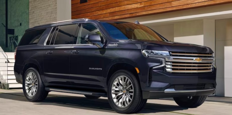 A black 2023 Chevrolet Suburban full-size SUV is parked. 