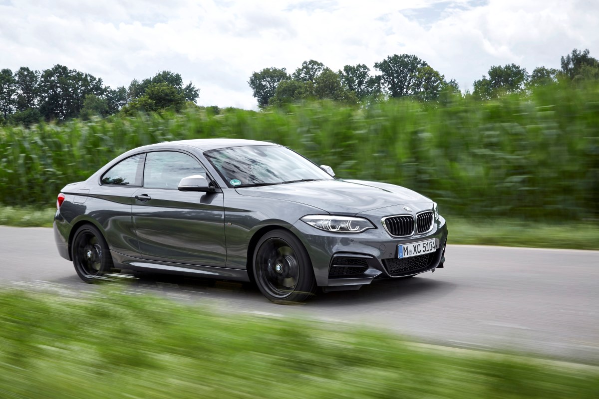 The BMW 2 Series with the twin scroll V8 engine driving in the countryside.