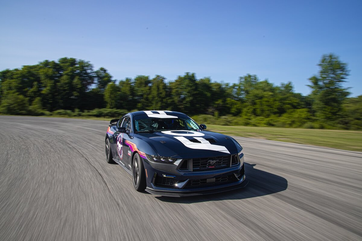 A Ford Mustang Dark Horse R shows off its aggressive fascia on the track.