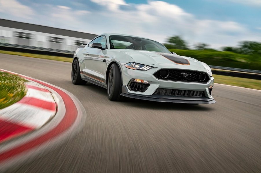 A two-tone 2023 Ford Mustang Mach 1 corners on a race track, displaying turning radius