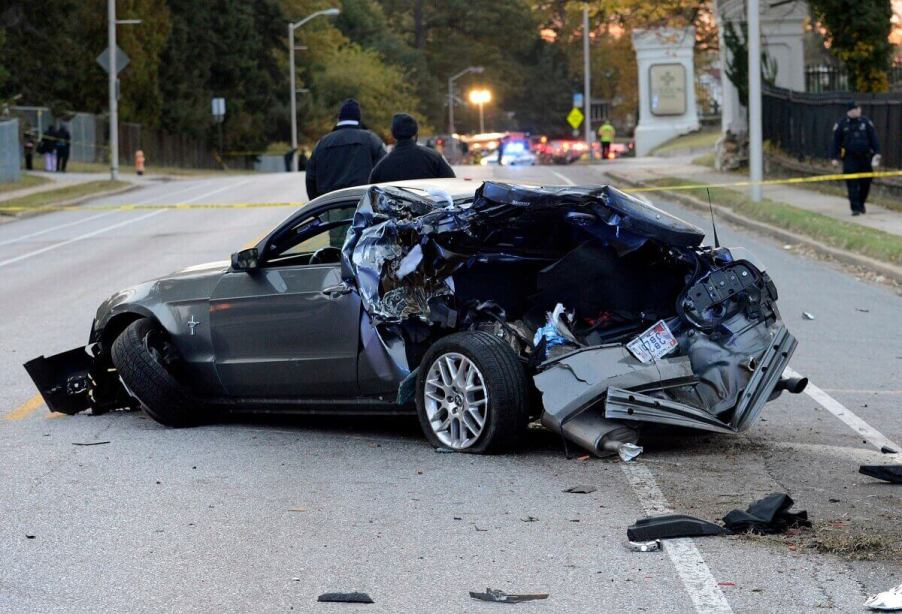 A gray S197 Ford Mustang sits in the road after the muscle car was involved in an crash.