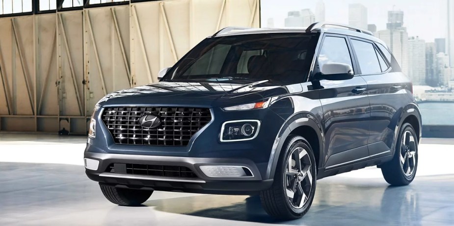 A blue 2023 Hyundai Venue subcompact SUV is parked. 