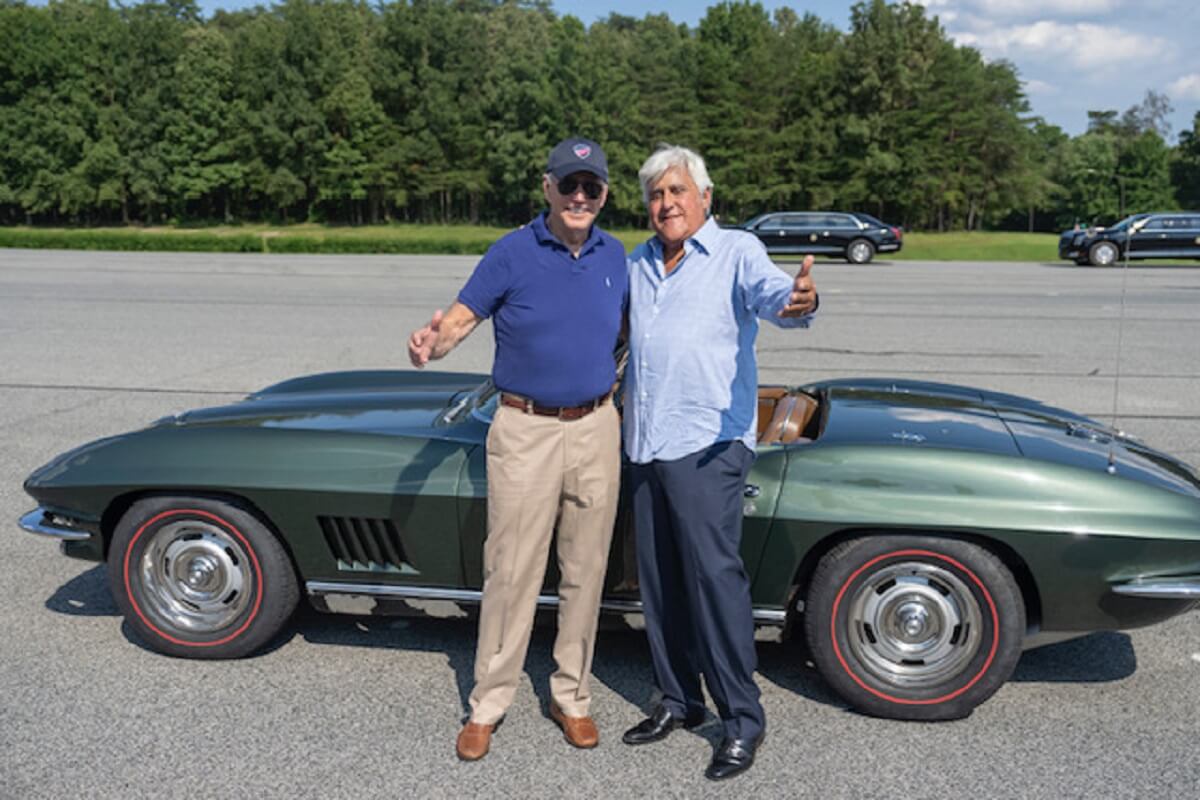 President Joe Biden smiles beside his 1967 Chevrolet Corvette Stingray as he stands alongside Jay Leno.