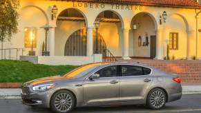 A 2015 Kia K900 driving down the road.