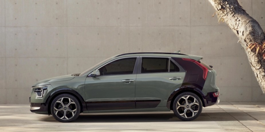 A green 2023 Kia Niro subcompact hybrid SUV is parked. 