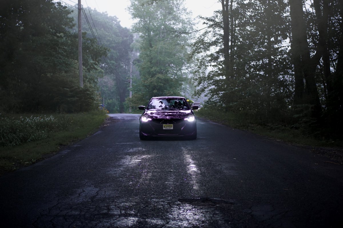 BMW M240i on a back road in the woods