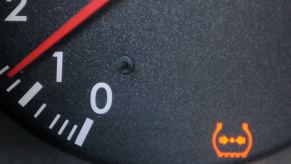 The dashboard of a Lexus luxury vehicle illuminated with a Tire Pressure Monitoring System (TPMS) warning light