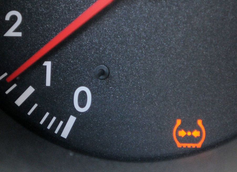 The TPMS (Tire Pressure Monitoring System) light on the dashboard of a Lexus model